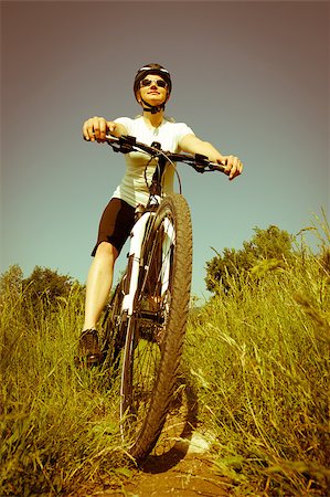 simsearch:400-04890875,k - Young girl riding a bike on a field path - offroad Stock Photo - Budget Royalty-Free & Subscription, Code: 400-04411535