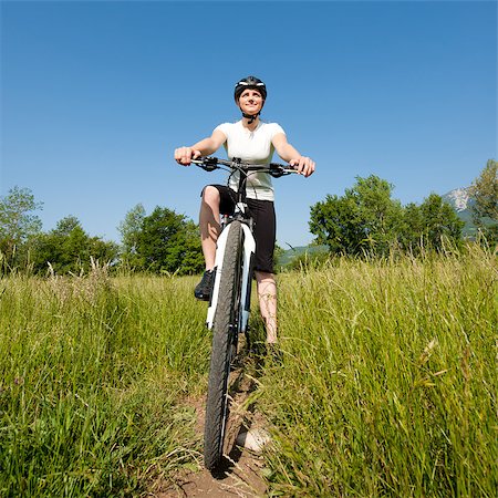 simsearch:400-04890875,k - Young girl riding a bike on a field path - offroad Stock Photo - Budget Royalty-Free & Subscription, Code: 400-04411531