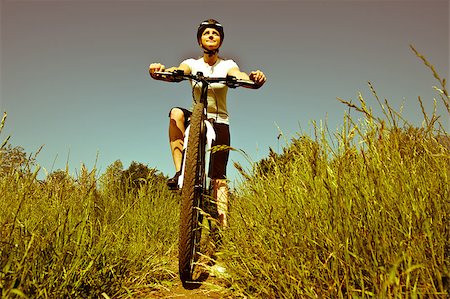 simsearch:400-04890875,k - Young girl riding a bike on a field path - offroad Stock Photo - Budget Royalty-Free & Subscription, Code: 400-04411533