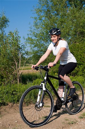 simsearch:400-04890875,k - Young girl riding a bike on a field path - offroad Stock Photo - Budget Royalty-Free & Subscription, Code: 400-04411543