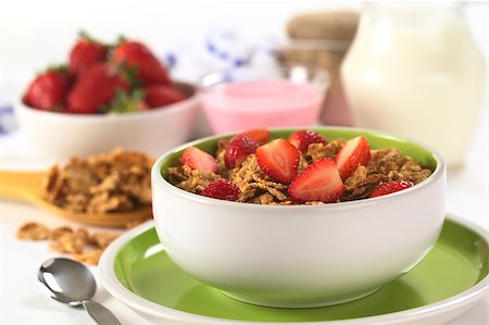 simsearch:400-04891088,k - Wholewheat flakes with fresh strawberry halves with strawberry yogurt, strawberries and milk in the back (Selective Focus, Focus on the strawberry half in the front) Stock Photo - Budget Royalty-Free & Subscription, Code: 400-04411955