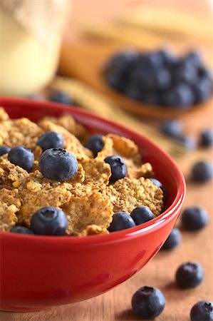 simsearch:400-04891088,k - Wholewheat flakes with fresh blueberries with a glass of yogurt and blueberries in the back (Selective Focus, Focus on the blueberry in the middle of the bowl) Stock Photo - Budget Royalty-Free & Subscription, Code: 400-04411952