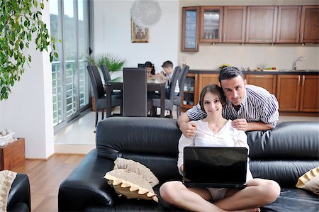 simsearch:400-04712944,k - happy young family have fun and working on laptop at modern  home livingroom indoor Stock Photo - Budget Royalty-Free & Subscription, Code: 400-04412281