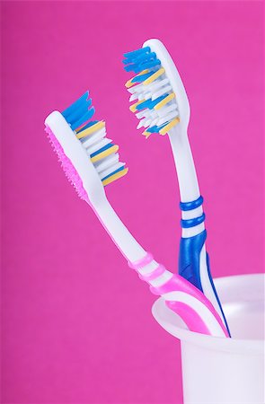 A couple of toothbrushes over pink background Stock Photo - Budget Royalty-Free & Subscription, Code: 400-04413071