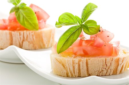 photo of delicious bruschetta with tomatoes on wooden table on isolated background Photographie de stock - Aubaine LD & Abonnement, Code: 400-04413274