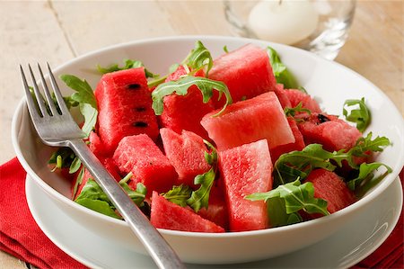 red water melon - photo of delicious fresh watermelon and arugula salad on wooden table Photographie de stock - Aubaine LD & Abonnement, Code: 400-04413285