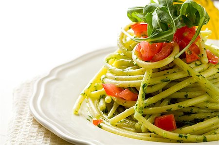 photo of delicious pasta with arugula pesto and cherry tomatoes Stock Photo - Budget Royalty-Free & Subscription, Code: 400-04413298