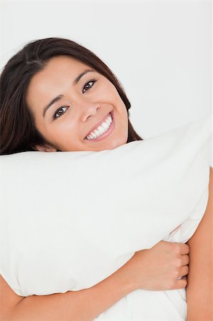 close up of a cute woman with pillow sitting on her bed looking into camera in bedroom Stock Photo - Budget Royalty-Free & Subscription, Code: 400-04413719
