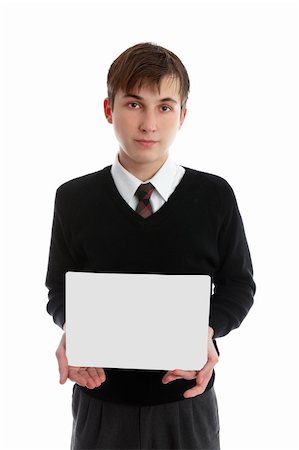 A teen boy holds a sign, book, brochure or other object in front of him.  White background. Stock Photo - Budget Royalty-Free & Subscription, Code: 400-04424871