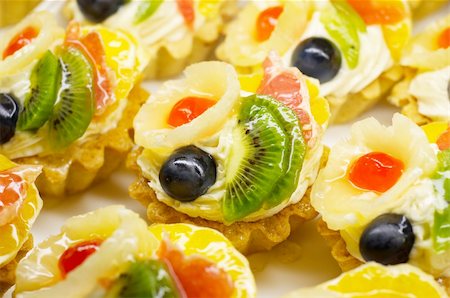 pineapple cake - Fruit cakes with pineapple, kiwi and grape berry on on top. Shallow DOF. Stock Photo - Budget Royalty-Free & Subscription, Code: 400-04425411