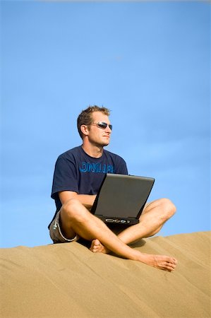 surfboard mobile - Surfer working on his laptop in the dunes in Gran Canaria Stock Photo - Budget Royalty-Free & Subscription, Code: 400-04426969