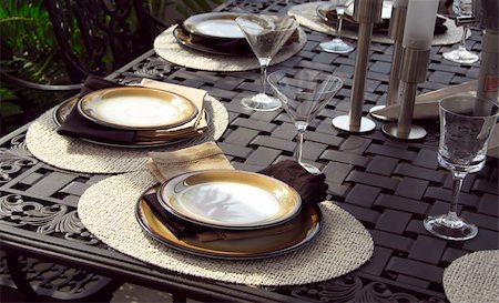 simsearch:400-04064749,k - Table setting on a patio table with plates and martini glasses Stock Photo - Budget Royalty-Free & Subscription, Code: 400-04427284