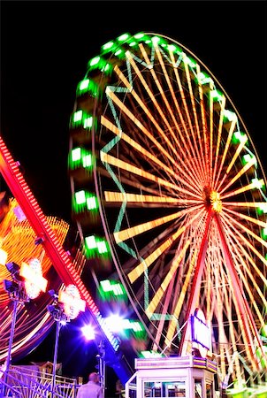 spinning wheel theme park ride - Fairground at night with bright lights and motion blur Stock Photo - Budget Royalty-Free & Subscription, Code: 400-04427626