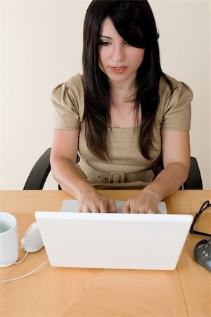 simsearch:400-04434095,k - A businesswoman typing information into a laptop computer. Photographie de stock - Aubaine LD & Abonnement, Code: 400-04428719