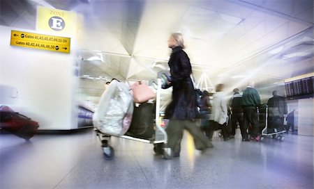 plane delay - Women with bags at the airport, motion blur Stock Photo - Budget Royalty-Free & Subscription, Code: 400-04428945