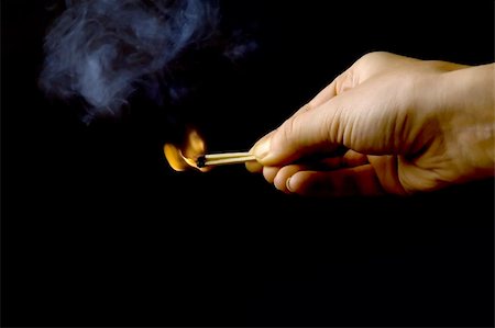 hand holding a burning match, isolated on black background Stock Photo - Budget Royalty-Free & Subscription, Code: 400-04429091