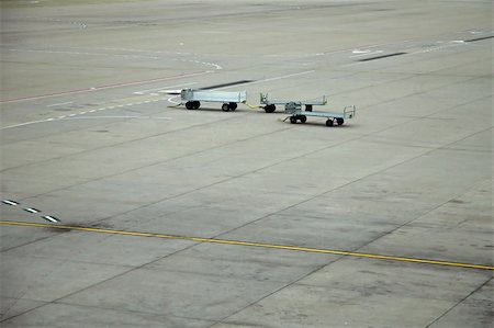 plane delay - airport scene, three luggage trolleys, grey concrete Stock Photo - Budget Royalty-Free & Subscription, Code: 400-04429474