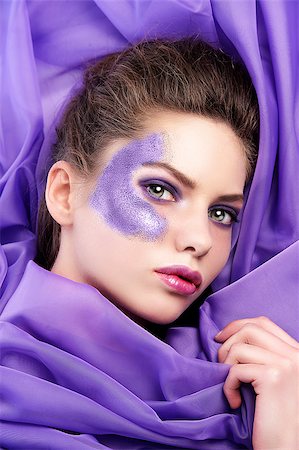 simsearch:400-04420197,k - head shot of a pretty young girl laying in the middle of purple fabric with glittering eye make up Stock Photo - Budget Royalty-Free & Subscription, Code: 400-04420198