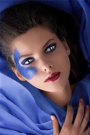 simsearch:400-04420197,k - beauty shot of a laying girl with blue glitter make up Stock Photo - Budget Royalty-Free & Subscription, Code: 400-04420201