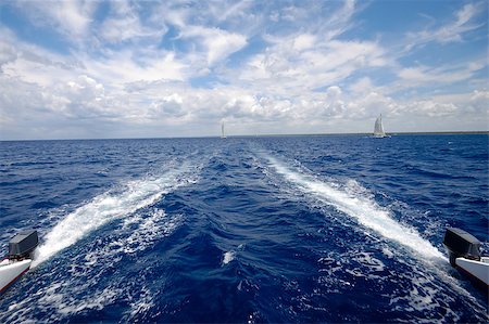 Sailing on a catemaran. With blue water and cloudscape. Stockbilder - Microstock & Abonnement, Bildnummer: 400-04420316
