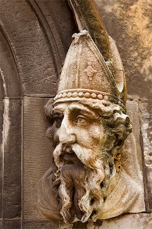 A stone carving of Saint Patrick on the lower door to the Chapel Royal of Dublin Castle in Dublin, Ireland. The stone is discolored with lichen and shows the effect of weather over the years. Stock Photo - Budget Royalty-Free & Subscription, Code: 400-04420425