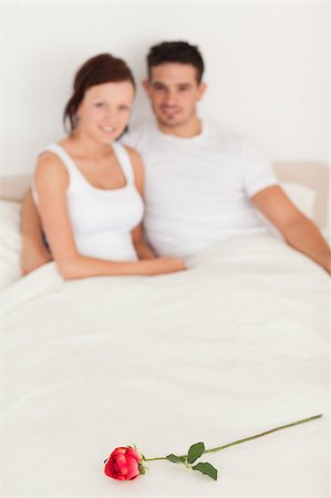 simsearch:400-04182849,k - Rose on a bed of happy couple in the bedroom Stock Photo - Budget Royalty-Free & Subscription, Code: 400-04420807