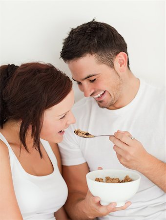 simsearch:400-04182849,k - Portrait of a man feeding cereal to his wife in the bedroom Stock Photo - Budget Royalty-Free & Subscription, Code: 400-04420824