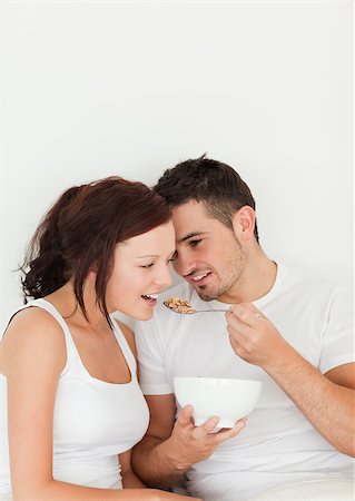 simsearch:400-04182849,k - Close up of a man feeding cereal to his wife in the bedroom Stock Photo - Budget Royalty-Free & Subscription, Code: 400-04420823
