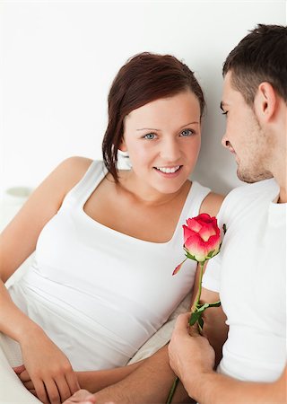 simsearch:400-04182849,k - Close up of a Cheerful couple with a rose looking into camera in the bedroom Stock Photo - Budget Royalty-Free & Subscription, Code: 400-04420830