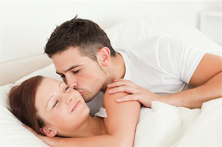 simsearch:400-04182849,k - Man kissing his wife on the cheek in the bedroom Stock Photo - Budget Royalty-Free & Subscription, Code: 400-04420847