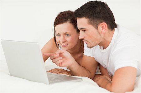 simsearch:400-04182849,k - Happy couple with a laptop in the bedroom Stock Photo - Budget Royalty-Free & Subscription, Code: 400-04420859