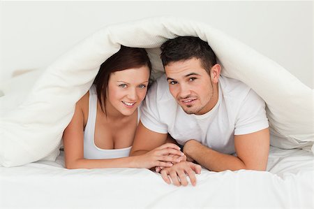 simsearch:400-04182849,k - Cherrful couple hiding under a blanket in the bedroom Stock Photo - Budget Royalty-Free & Subscription, Code: 400-04420852