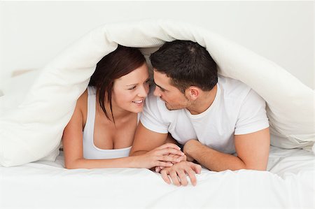 simsearch:400-04182849,k - Happy couple hiding under a blanket in a bedroom Stock Photo - Budget Royalty-Free & Subscription, Code: 400-04420853