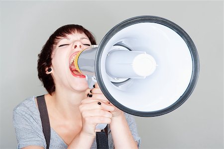 simsearch:400-06763387,k - angry teenage girl yelling into a megaphone - isolated on gray Stock Photo - Budget Royalty-Free & Subscription, Code: 400-04421210