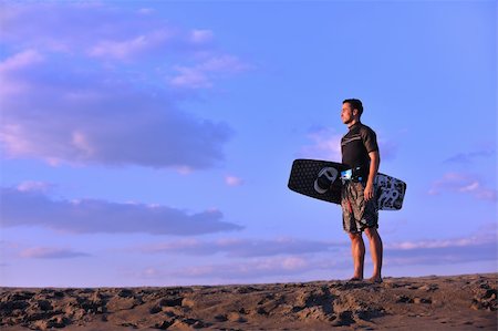 surfers men model - Portrait of a strong young  surf  man at beach on sunset in a contemplative mood with a surfboard Stock Photo - Budget Royalty-Free & Subscription, Code: 400-04423816
