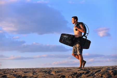 surfers men model - Portrait of a strong young  surf  man at beach on sunset in a contemplative mood with a surfboard Stock Photo - Budget Royalty-Free & Subscription, Code: 400-04423817