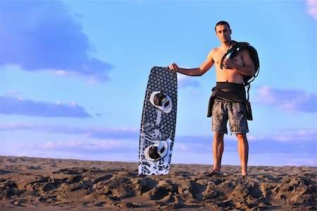 surfers men model - Portrait of a strong young  surf  man at beach on sunset in a contemplative mood with a surfboard Stock Photo - Budget Royalty-Free & Subscription, Code: 400-04423818
