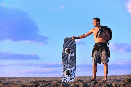 surfers men model - Portrait of a strong young  surf  man at beach on sunset in a contemplative mood with a surfboard Stock Photo - Budget Royalty-Free & Subscription, Code: 400-04423819