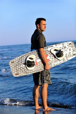 surfers men model - Portrait of a strong young  surf  man at beach on sunset in a contemplative mood with a surfboard Stock Photo - Budget Royalty-Free & Subscription, Code: 400-04423813