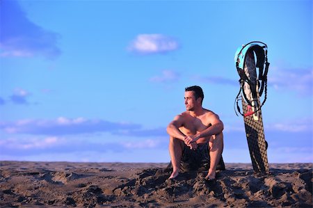 surfers men model - Portrait of a strong young  surf  man at beach on sunset in a contemplative mood with a surfboard Stock Photo - Budget Royalty-Free & Subscription, Code: 400-04423820