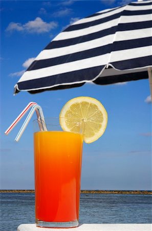 Tropical drink with sunny beach and parasol background Stock Photo - Budget Royalty-Free & Subscription, Code: 400-04434159