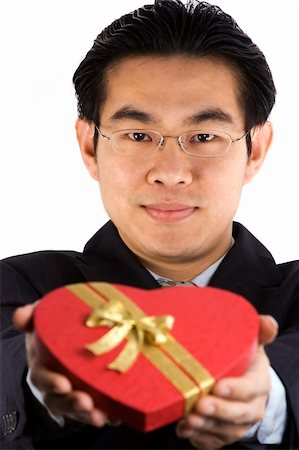 simsearch:400-05294518,k - Asian young guy holding a heart shape gift box. Fotografie stock - Microstock e Abbonamento, Codice: 400-04434182