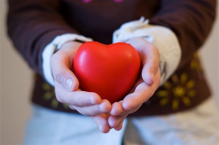 simsearch:400-05701644,k - The hands of a chindren holding a red heart (focus on the heart) Stock Photo - Budget Royalty-Free & Subscription, Code: 400-04434365