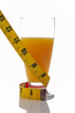 simsearch:400-05148141,k - A glass of juice of orange with a metric coiled tape reflected on white background Stockbilder - Microstock & Abonnement, Bildnummer: 400-04435130