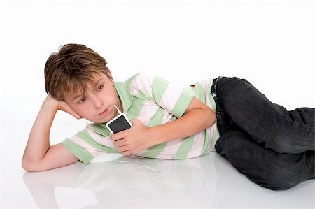 simsearch:400-04434331,k - A child relaxes with a portable digital mp3 player Photographie de stock - Aubaine LD & Abonnement, Code: 400-04435204
