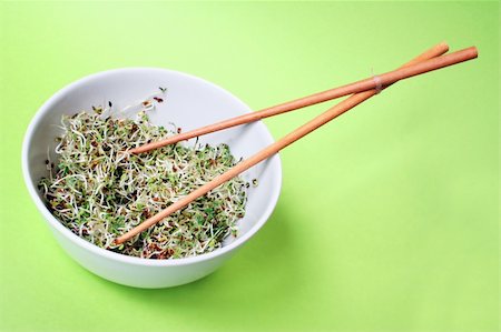 Fresh spouts in bowl with chopsticks and green background Stock Photo - Budget Royalty-Free & Subscription, Code: 400-04435949