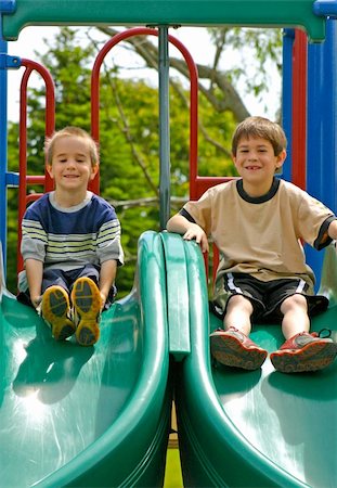 simsearch:400-05166871,k - Two Boys Playing on a double slide Foto de stock - Royalty-Free Super Valor e Assinatura, Número: 400-04436214