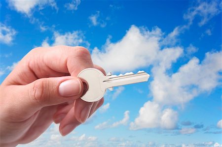 simsearch:400-04350998,k - Woman's hand holding key with pretty sky background Stock Photo - Budget Royalty-Free & Subscription, Code: 400-04436406