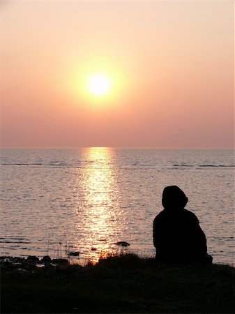 portrait of human at ocean watching the beautiful sunset Fotografie stock - Microstock e Abbonamento, Codice: 400-04437149
