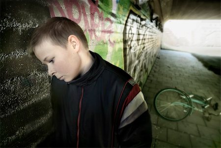 upset boy leaning against a wall Stock Photo - Budget Royalty-Free & Subscription, Code: 400-04437402